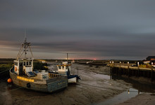 Fishing Boats At Night. Brancaster Staithe, Norfolk, UK.