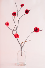 Red Paper Roses On A Tree Twig In A Vase