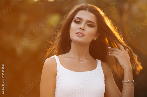 Portrait Of A Beautiful Brunette Girl With Wavy Thick Hair On A