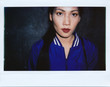 © Stocksy - Instant wide polaroid photo of a beautiful Asian woman in blue bomber jacket