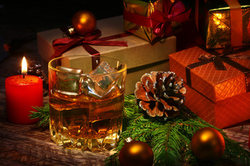 Wall Mural - Glass with cognac or whiskey, Christmas balls and candles. New Year's tree, balls and glass with alcohol.