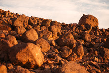 Desert Landscape With Small Stones On Large One