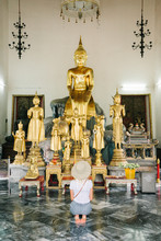 Woman In Temple In Front Of Statues