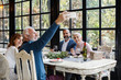 © Stocksy - Friends Taking Selfie at Restaurant