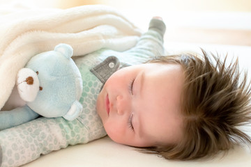 Wall Mural - Sleepy little baby boy taking a nap