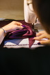 © Stocksy - Young woman making clothes by herself at home
