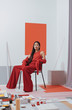 © Stocksy - Asian fashionable female model with long hair in red in abstract space ./Fashion series