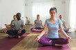 © Stocksy - Group of people doing meditation in yoga class