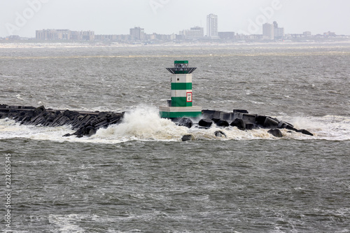 Fotografie, Obraz Dutch pier IJmuiden with lighthouse and stormy sea