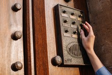 Crop Female's And Touching The Vintage Doorbell