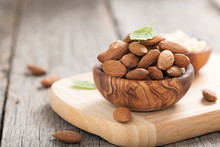 Almonds Nuts In Wooden Bowl On Rustic Table.