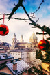 Beautiful view of the historic city of Salzburg with famous Salzburg Cathedral in winter,  Austria.Christmas trees with red Christmas balls against the background of the winter Salzburg.
