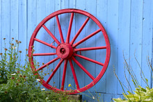 Old Red Wagon Wheel On Blue Barn 