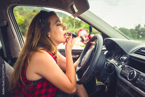 Fotografie, Obraz Young reckless girl in car doing make up