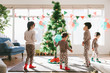 © Stocksy - Kids decorating christmas tree at home