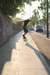 © Stocksy - Teenager riding skateboard on the sidewalk