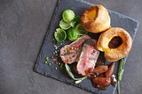 Fototapeta Mapy - 
    Roast beef with yorkshire pudding, brussels sprouts and shallots. Traditional british roast beef. Overhead view