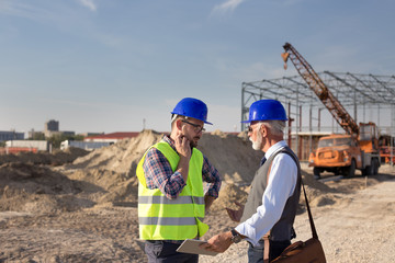 Enginers talking at building site