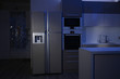 Kitchen interior with four door refrigerator at night