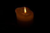 Fototapeta  - Burning candle in the dark. glowing flame