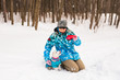 © satura_ - Pets owner and winter concept - Middle aged woman playing with her jack russell terrier dog in snowy park.