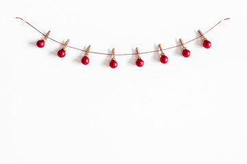 Christmas composition. Garland made of red balls on white background. Christmas, winter, new year concept. Flat lay, top view, copy space