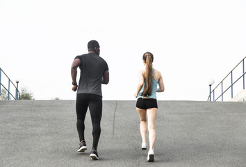 happy young couple afro-american man and european woman running together. A loving couple is run, engaged in sports, family values