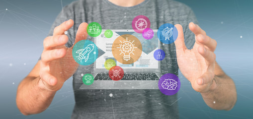 Poster - businessman holding a cloud of colorfull start up icon bubble with a laptop 3d rendering