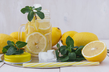 lemon juice and ice mint on a white wooden table