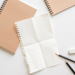 Wall Mural - fold graph paper with spiral notebook, pencil and eraser on white background.empty space for yourtex