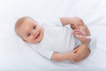 happy beautiful baby girl in white body suit