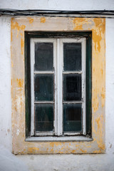 old window of abandoned house in ruins