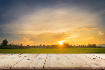 Rice field sunset and Empty wood table for product display and montage.