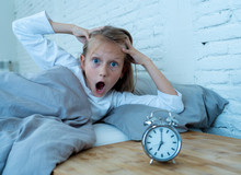 Cute Girl Waking With Alarm Clock Feeling Tired And Angry Time To Go To School Early In The Morning