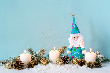 Wall Mural - Christmas blue composition. Candles and dwarf among fir branches