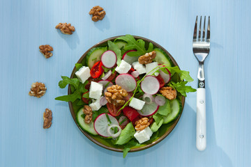 Salad of fresh vegetables, walnuts and feta cheese. Healthy diet concept.