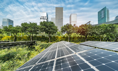 Wall Mural - ecological energy renewable solar panel plant with urban landscape landmarks