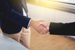 © pakphoto - Businessman shaking hands to make business dealing