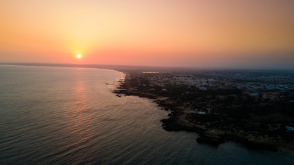 Aerial view of sunset over the coast Algarve coast, Portugal. Concept for above Lagos beach of Portugal. Summer vacations