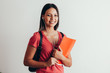 © kleberpicui - Portrait of a cheerful smiling african student girl wearing backpack and holding books isolated over white background
