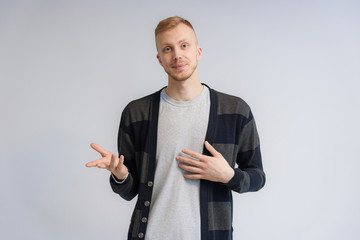 Studio portrait concept of a smiling young man talking on a white background.