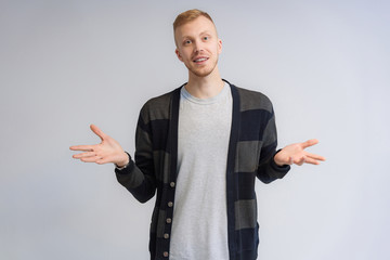 Studio portrait concept of a smiling young man talking on a white background.