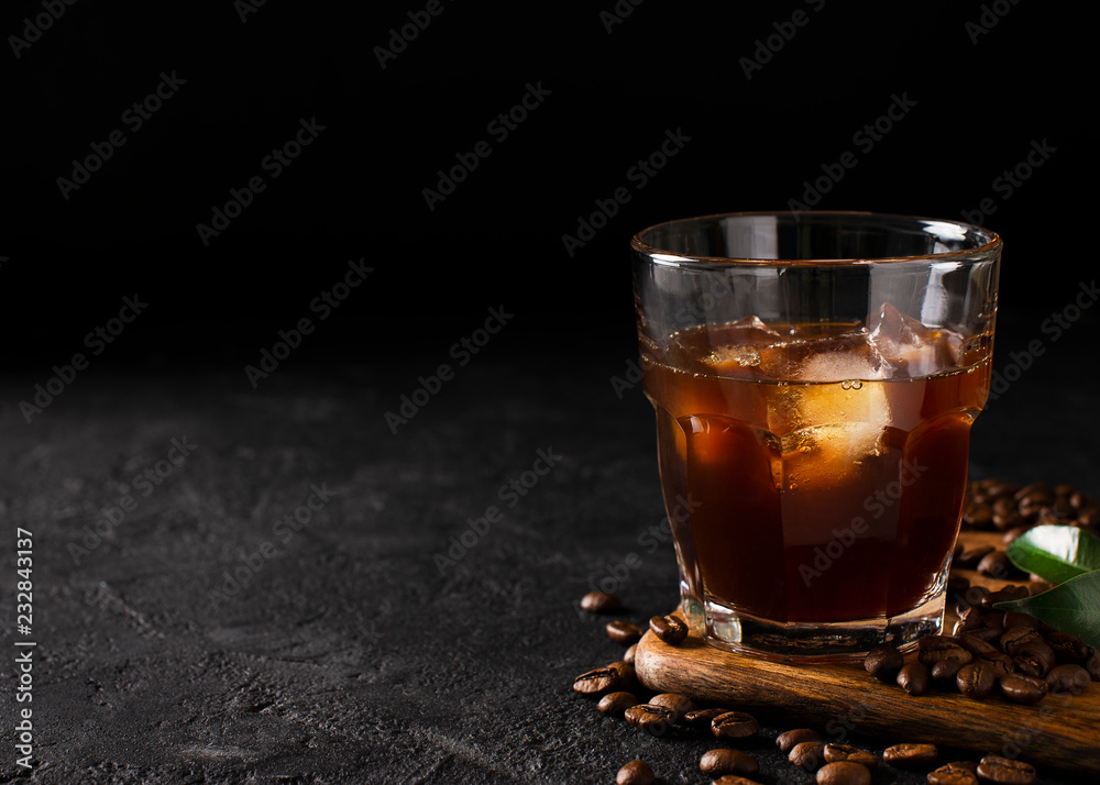 glass cold brew coffee with ice on black or dark background - obrazy, fototapety, plakaty 