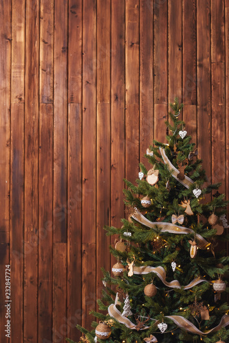 Rustic Christmas Tree On A Wooden Background Burlap Ribbon On The