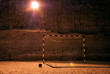 Football gate and soccer ball on a dark background and artificial lighting