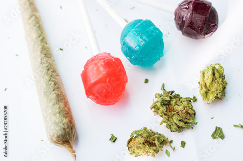 Cuadros en Lienzo Cannabis flower buds with THC infused candy lollipops and hand rolled marijuana