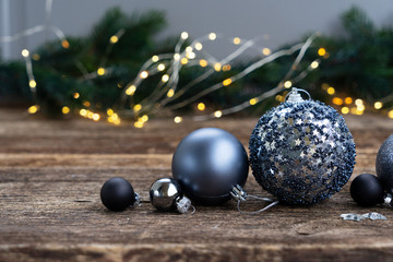 Elegant gray christmas scene on natural wood background with lights in background