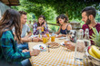 © oneinchpunch - Group of friends having breakfast in a farmhouse
