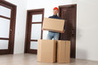 © dzmitrock87 - Relocation worker with cardboard boxes in apartment