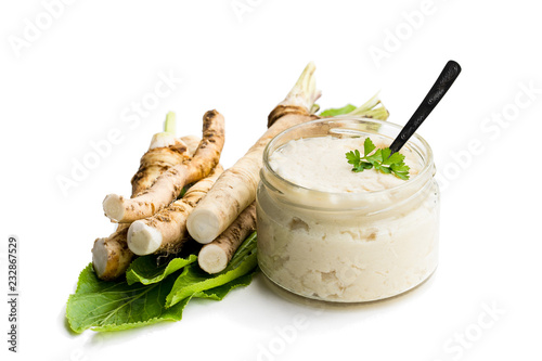 Cuadros en Lienzo Spicy horseradish sauce in glass jar isolated on white